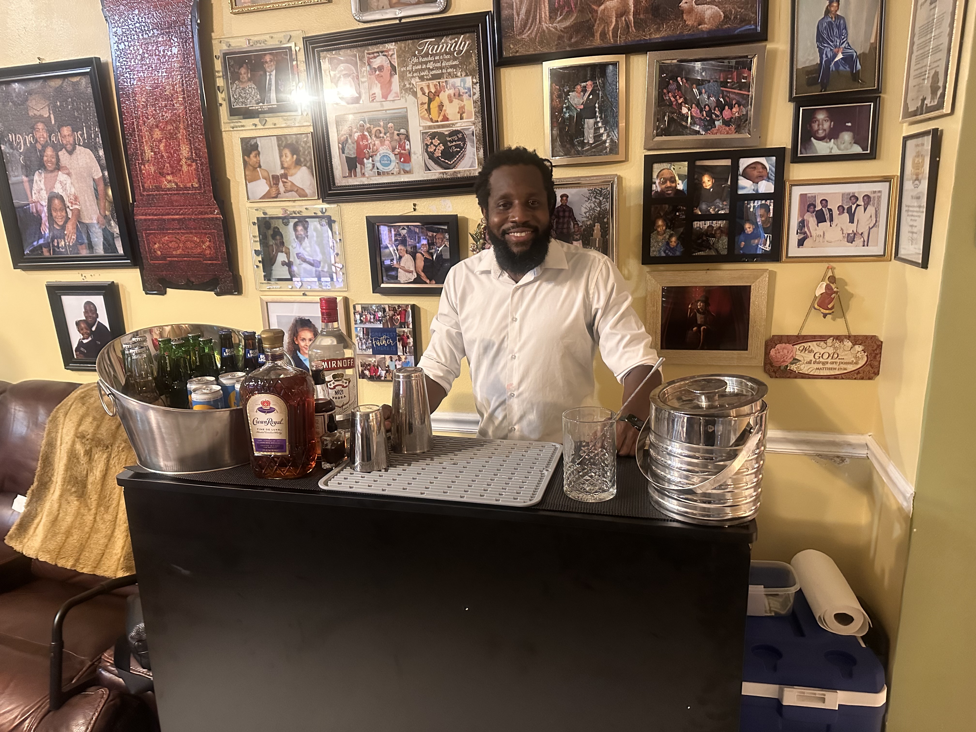 Daniel smiling behind a fully set up bar cart